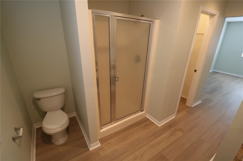 6750 Moonglow Drive, Unit 102 Port Richey, FL 34668 - Photo 18 of 26 a bathroom with a toilet and a shower