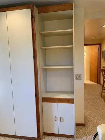 a view of walk in closet with empty racks