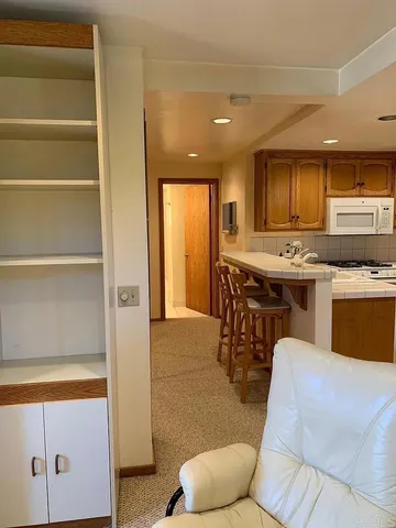 a kitchen with stainless steel appliances granite countertop a stove and a refrigerator