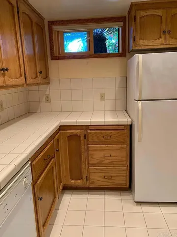 a view of a storage and utility room with washer and dryer