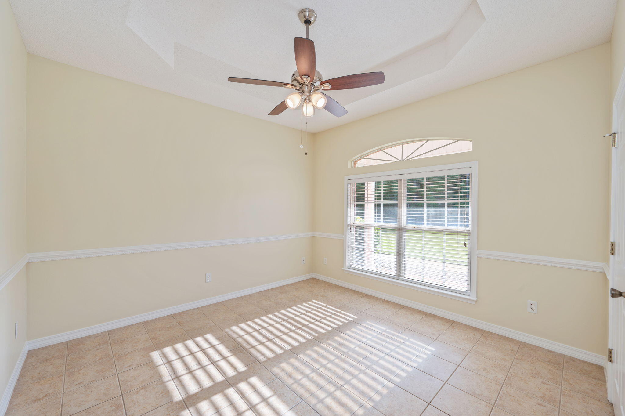 5552 Frontier Drive Crestview, FL 32536 - Photo 12 of 50 an empty room with windows and fan