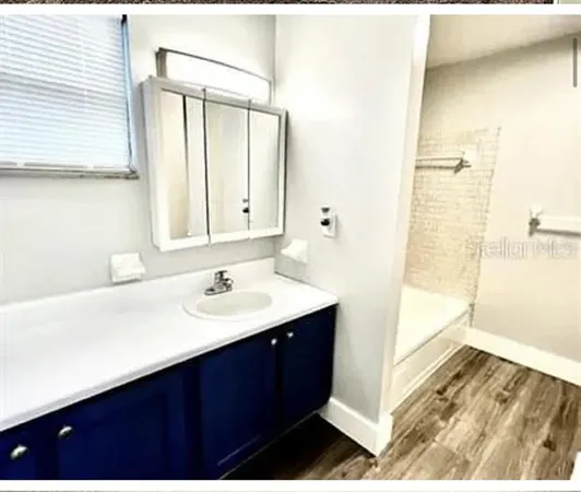 a bathroom with a sink a mirror and a shower