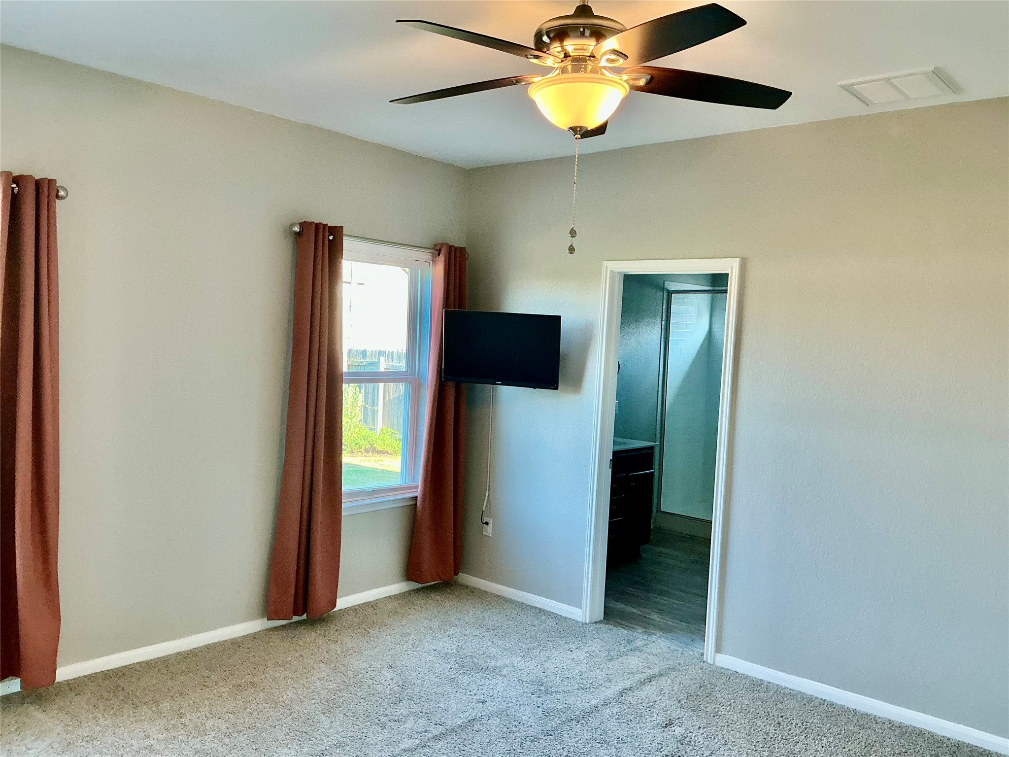 305 Rusk Bluff Avenue Leander, TX 78641 - Photo 22 of 34 Primary bedroom with a wall mounted TV