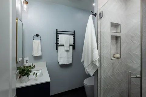a bathroom with a sink toilet and shower