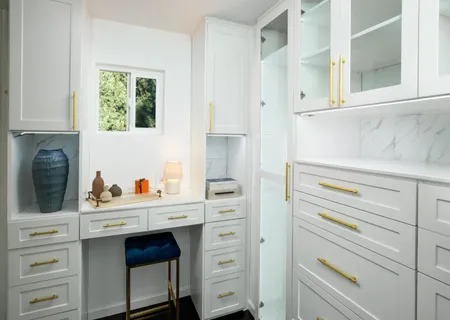 a kitchen with a stove cabinets and a window