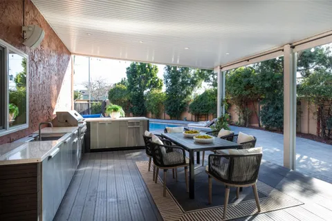 a view of a patio with a dining table and chairs