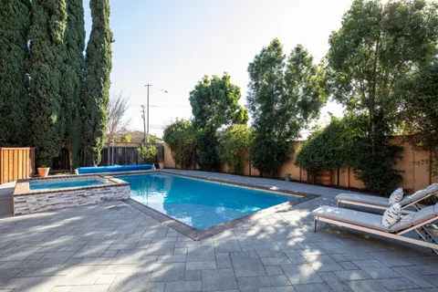 a view of a swimming pool with lounge chair
