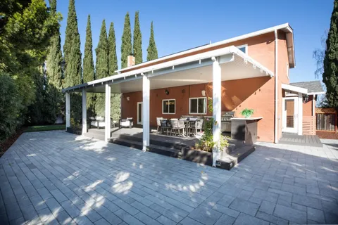 a view of a house with backyard porch and sitting area