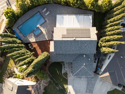 an aerial view of a house with a yard