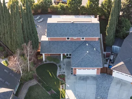 an aerial view of a house with a yard