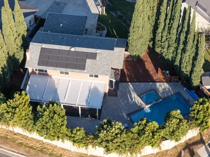 an aerial view of a house with a yard