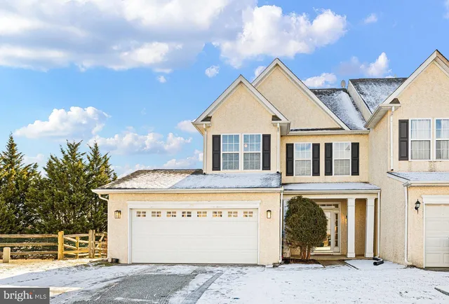 a view of a house with a garage and yard