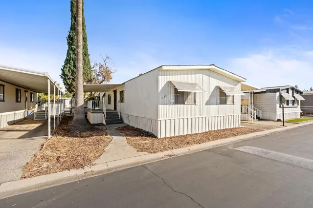 a view of a house with a small yard