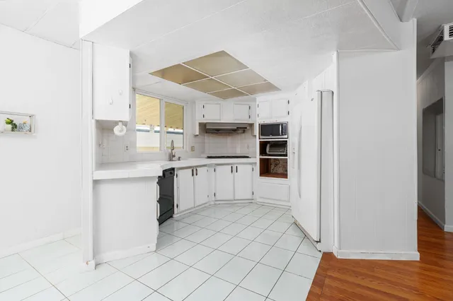 a kitchen with stainless steel appliances a refrigerator and cabinets