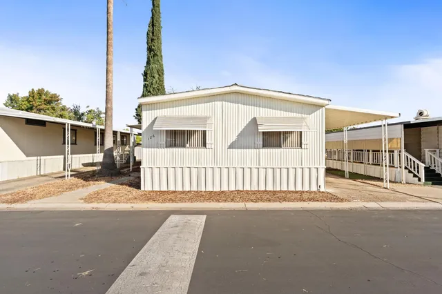 a front view of a house with a road