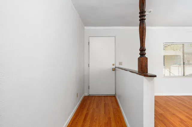 a view of hallway with wooden floor