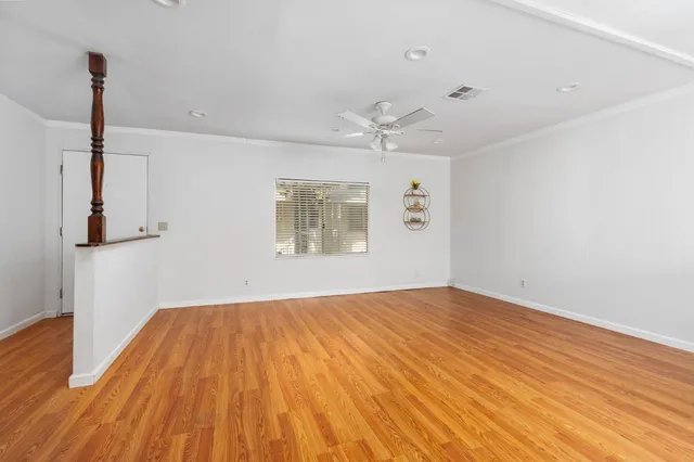 a large white kitchen with kitchen island a sink stainless steel appliances and cabinets