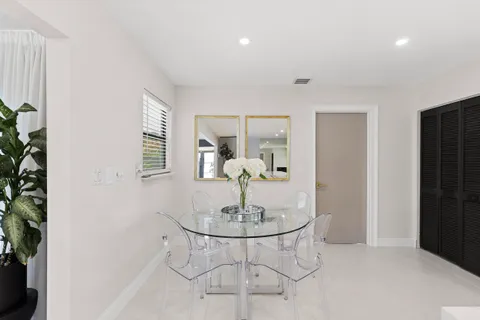 a dining room with table and chairs