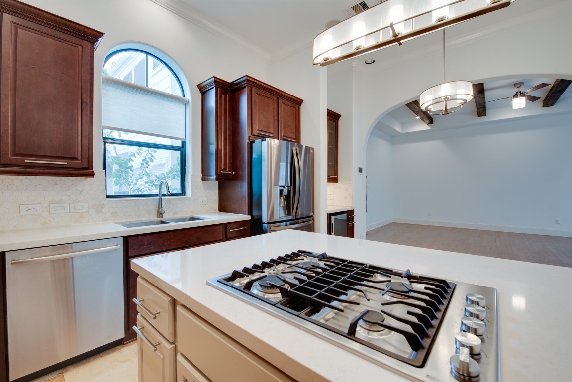 705 Malone Street, Unit B Houston, TX 77007 - Photo 17 of 39 a kitchen with wooden cabinets and a stove