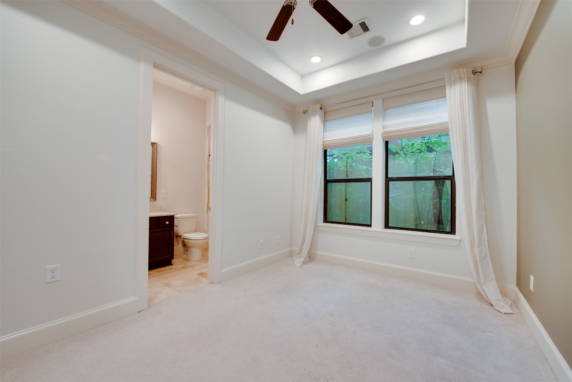 705 Malone Street, Unit B Houston, TX 77007 - Photo 4 of 39 an empty room with ceiling fan and window