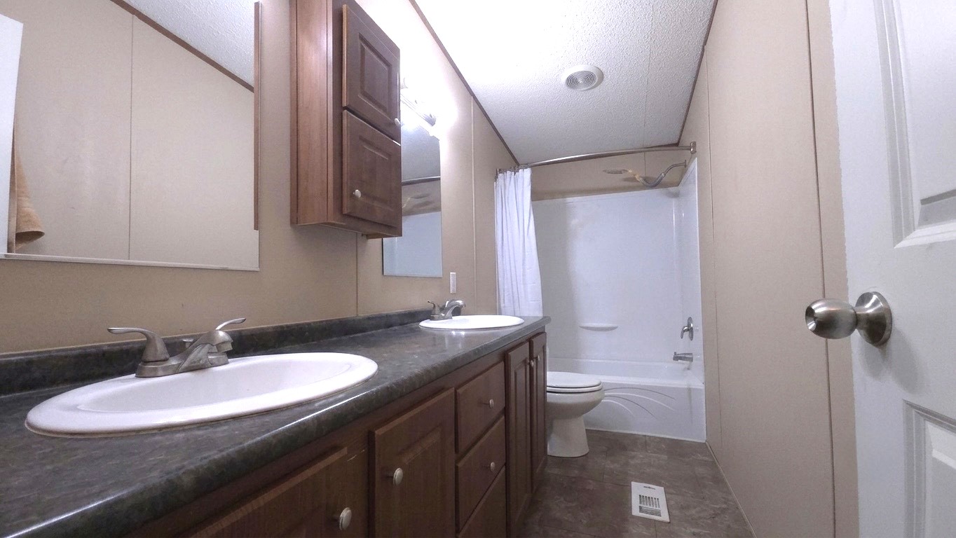 305 Thompson Road Dale, TX 78616 - Photo 9 of 11 Dual sinks set in a spacious vanity flank a traditional tub and shower combination.