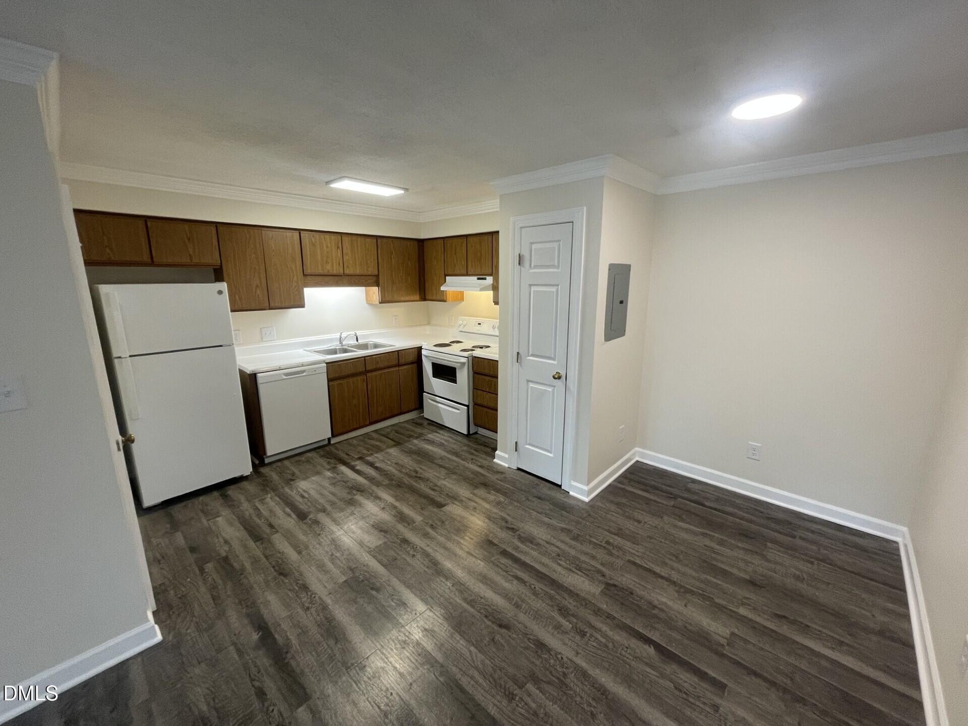 3535 Ivy Commons Drive, Unit 102 Raleigh, NC 27606 - Photo 3 of 9 a view of kitchen with a sink refrigerator and wooden floor