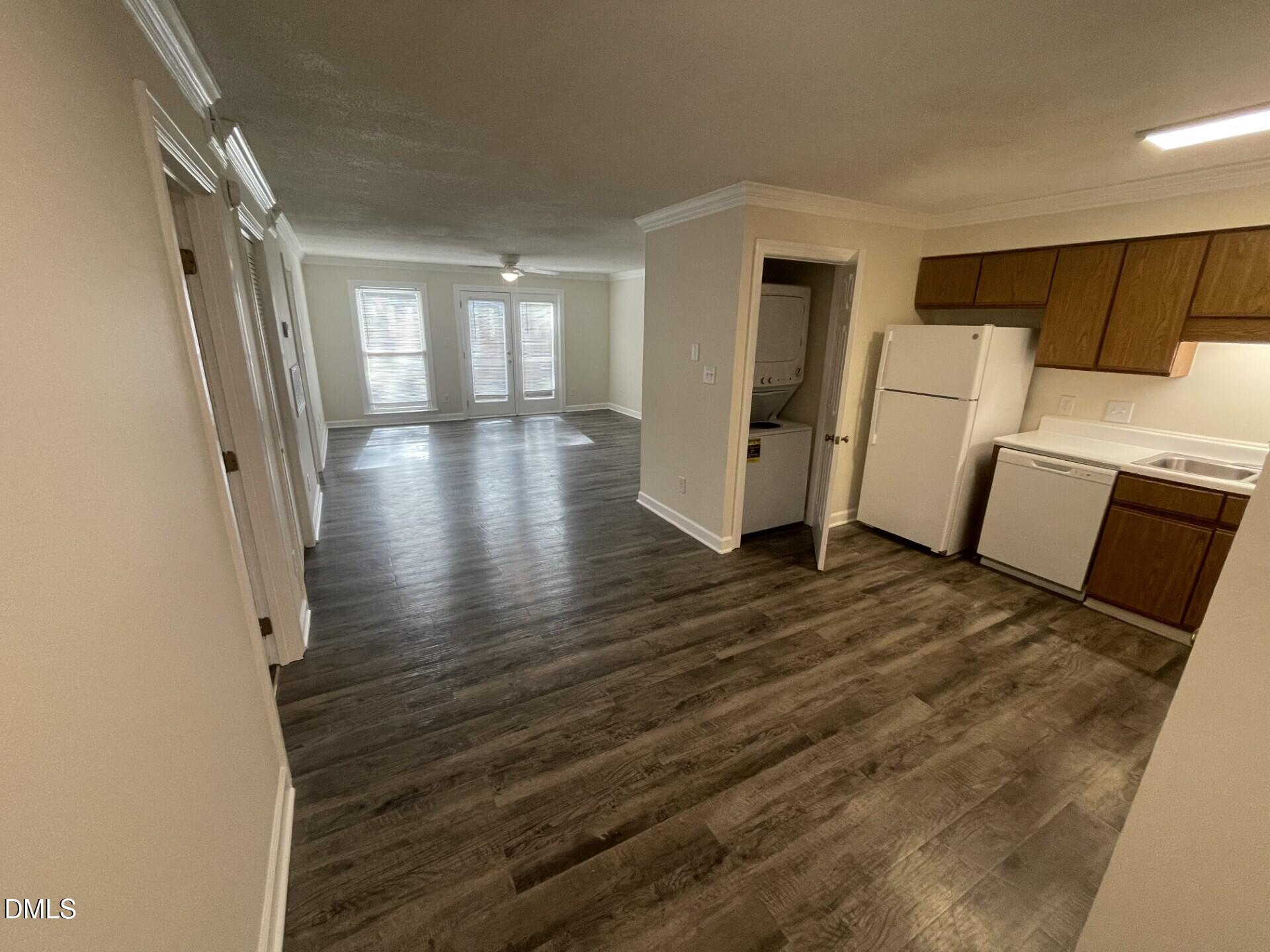 3535 Ivy Commons Drive, Unit 102 Raleigh, NC 27606 - Photo 4 of 9 a view of a hallway with wooden floor and stairs