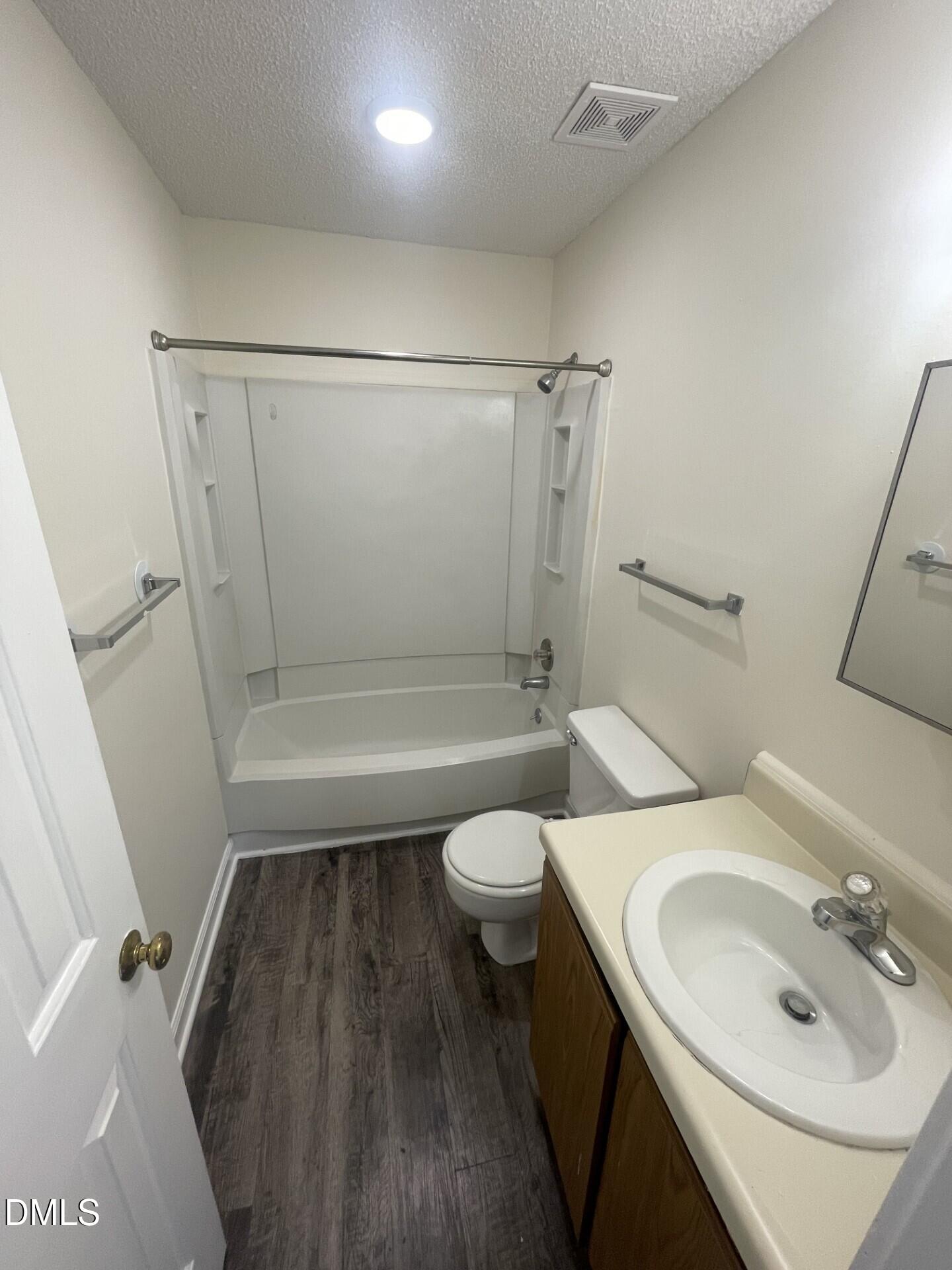 3535 Ivy Commons Drive, Unit 102 Raleigh, NC 27606 - Photo 7 of 9 a bathroom with a sink a toilet and shower
