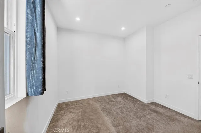 a view of a hallway with washer and dryer