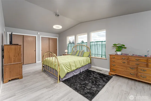 a bedroom with a bed and large window