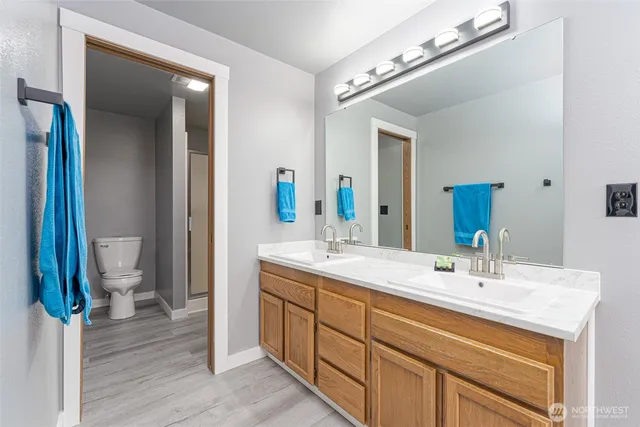 a bathroom with a tub sink and mirror
