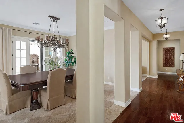 a view of a dining room with furniture and chandelier