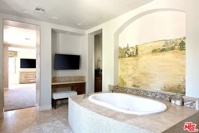 a spacious bathroom with a tub and a sink