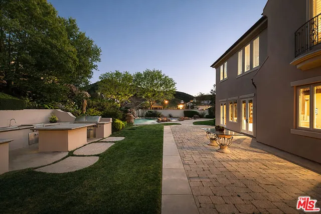 a view of a house with backyard porch and sitting area