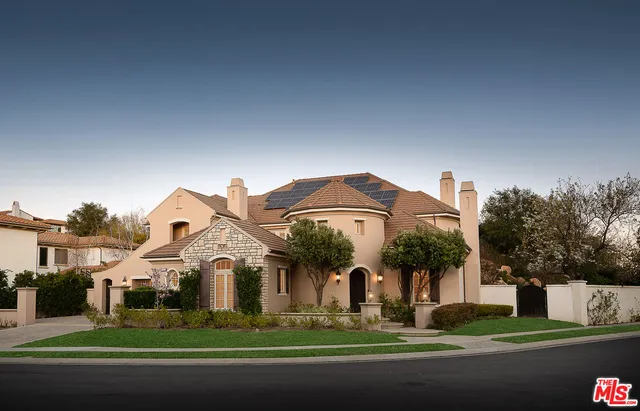 a front view of multiple houses with yard