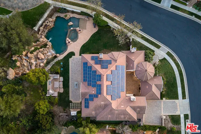 an aerial view of residential house with outdoor space and swimming pool