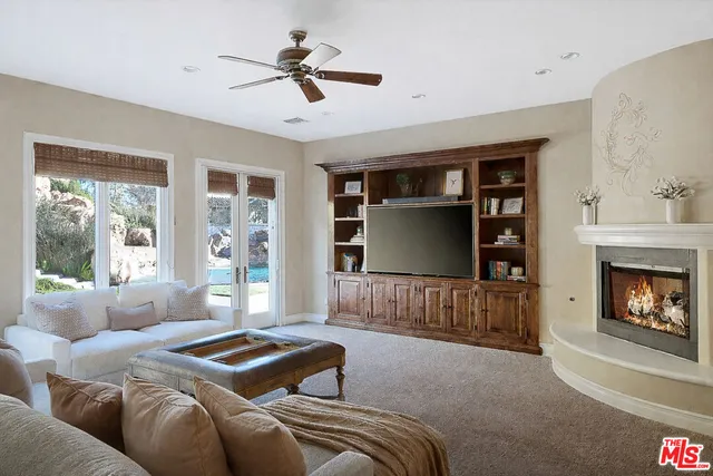a living room with furniture a window and a fireplace