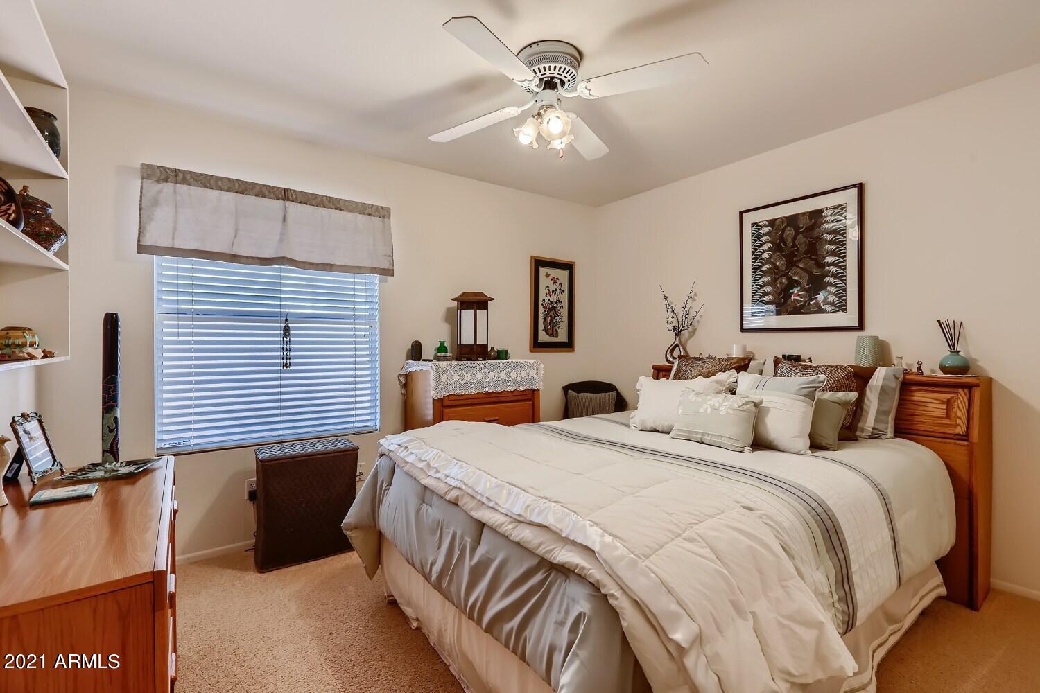 4307 East St John Road Phoenix, AZ 85032 - Photo 23 of 27 a bedroom with double bed and a chandelier