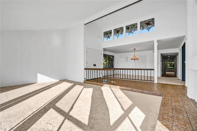 a view of empty room with wooden floor and a fireplace