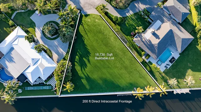 an aerial view of a residential houses with outdoor space and street view