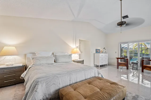 a bedroom with double bed and a large window