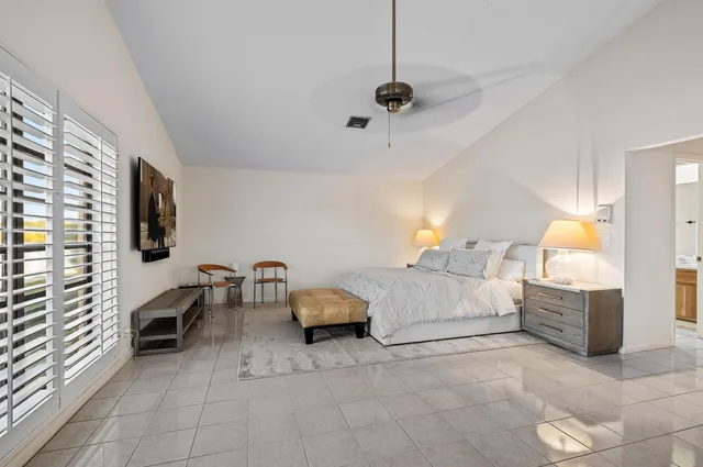 a spacious bedroom with a bed and a couch