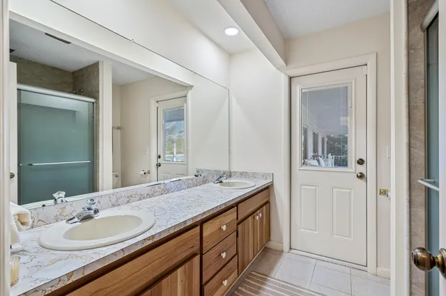 a bathroom with a granite countertop sink and a mirror