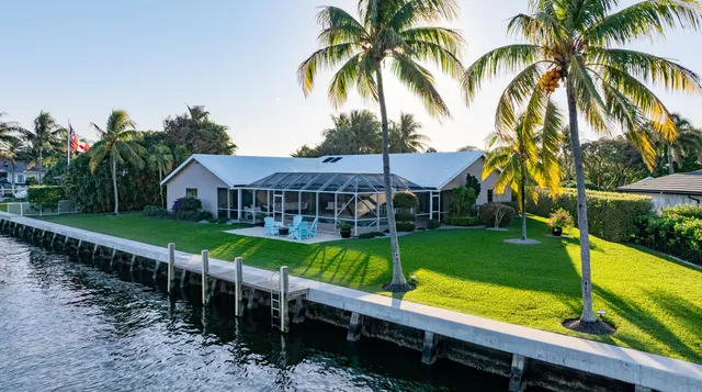 a view of a house with pool and a yard