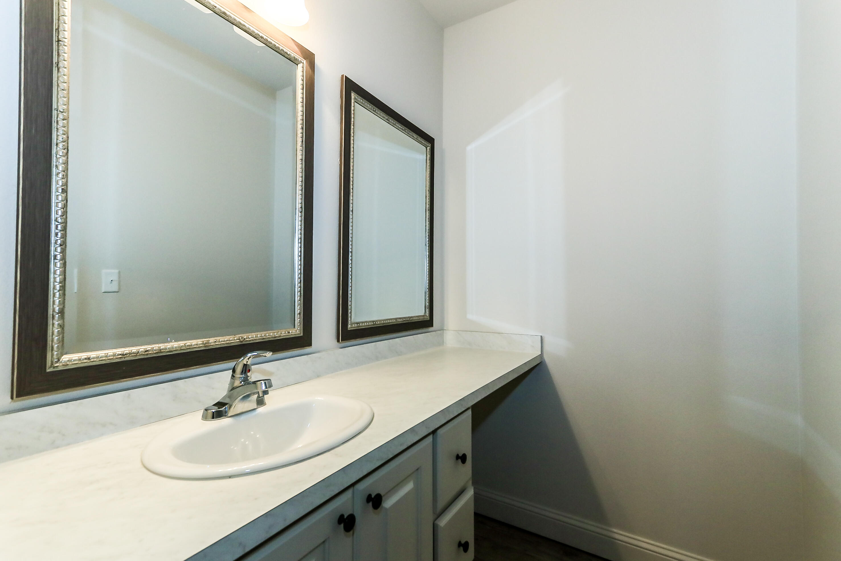 2518 B 111th Street Lubbock, TX 79423 - Photo 13 of 23 a bathroom with a sink and a mirror