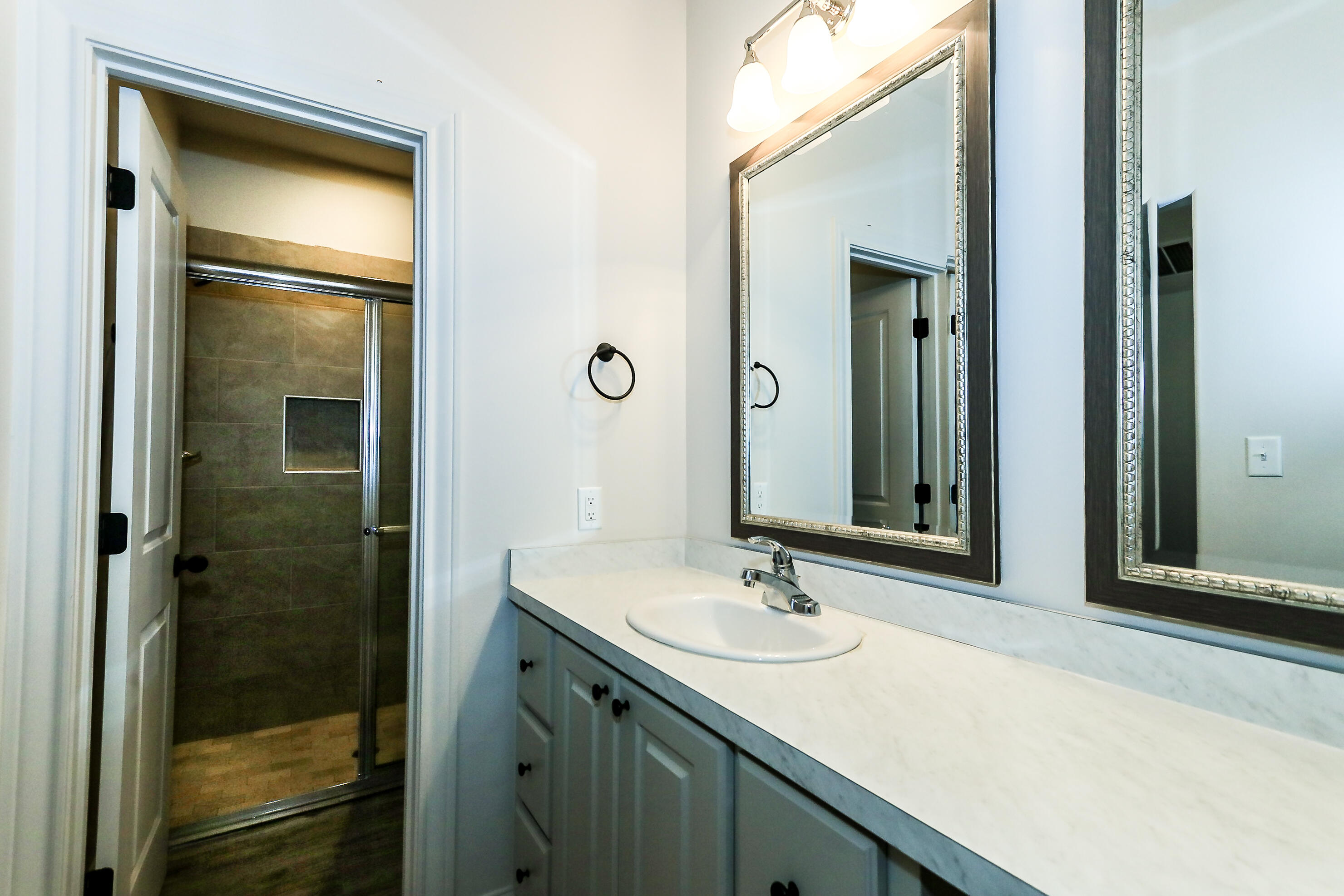 2518 B 111th Street Lubbock, TX 79423 - Photo 14 of 23 a bathroom with a sink and a mirror
