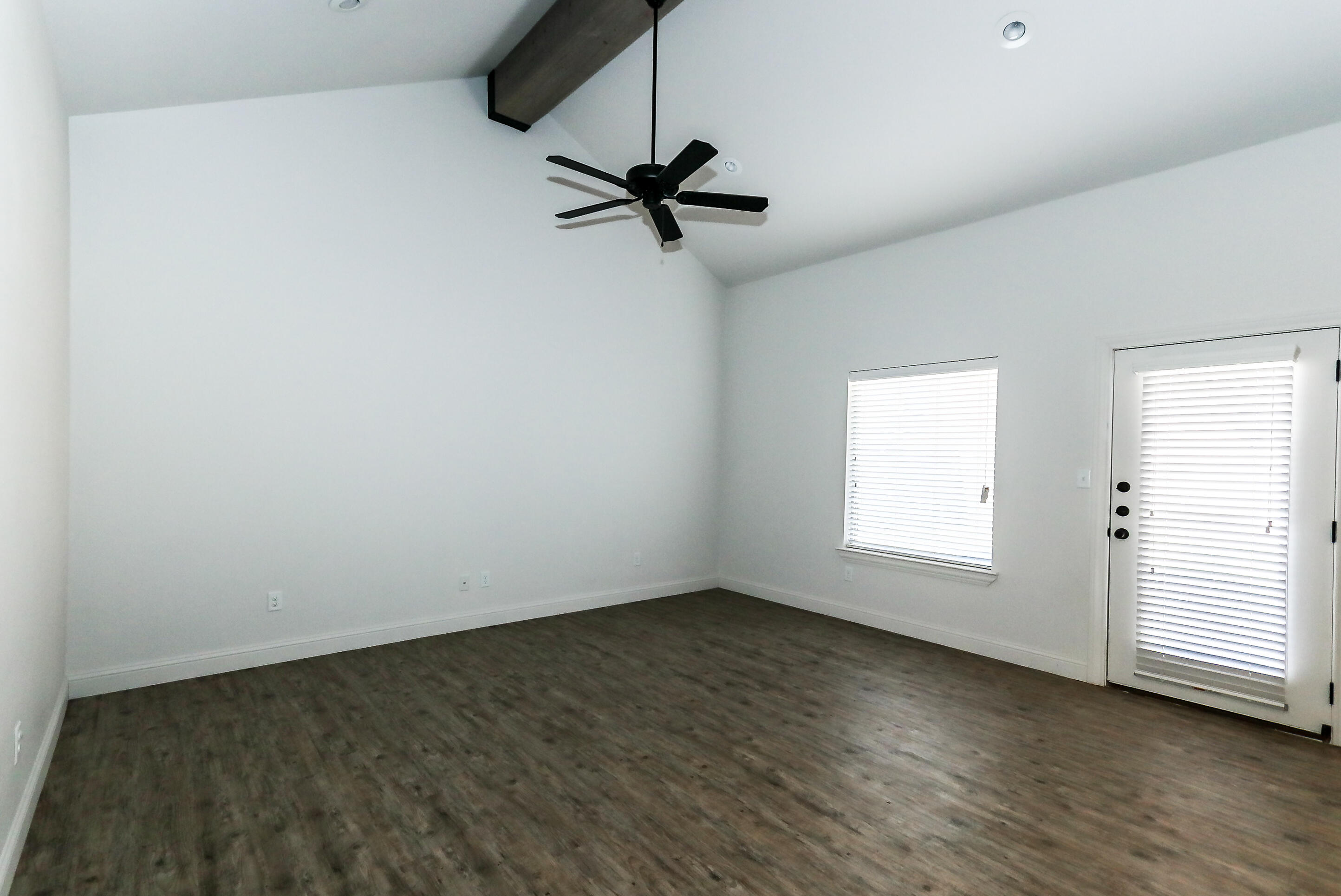 2518 B 111th Street Lubbock, TX 79423 - Photo 4 of 23 wooden floor in an empty room with a window