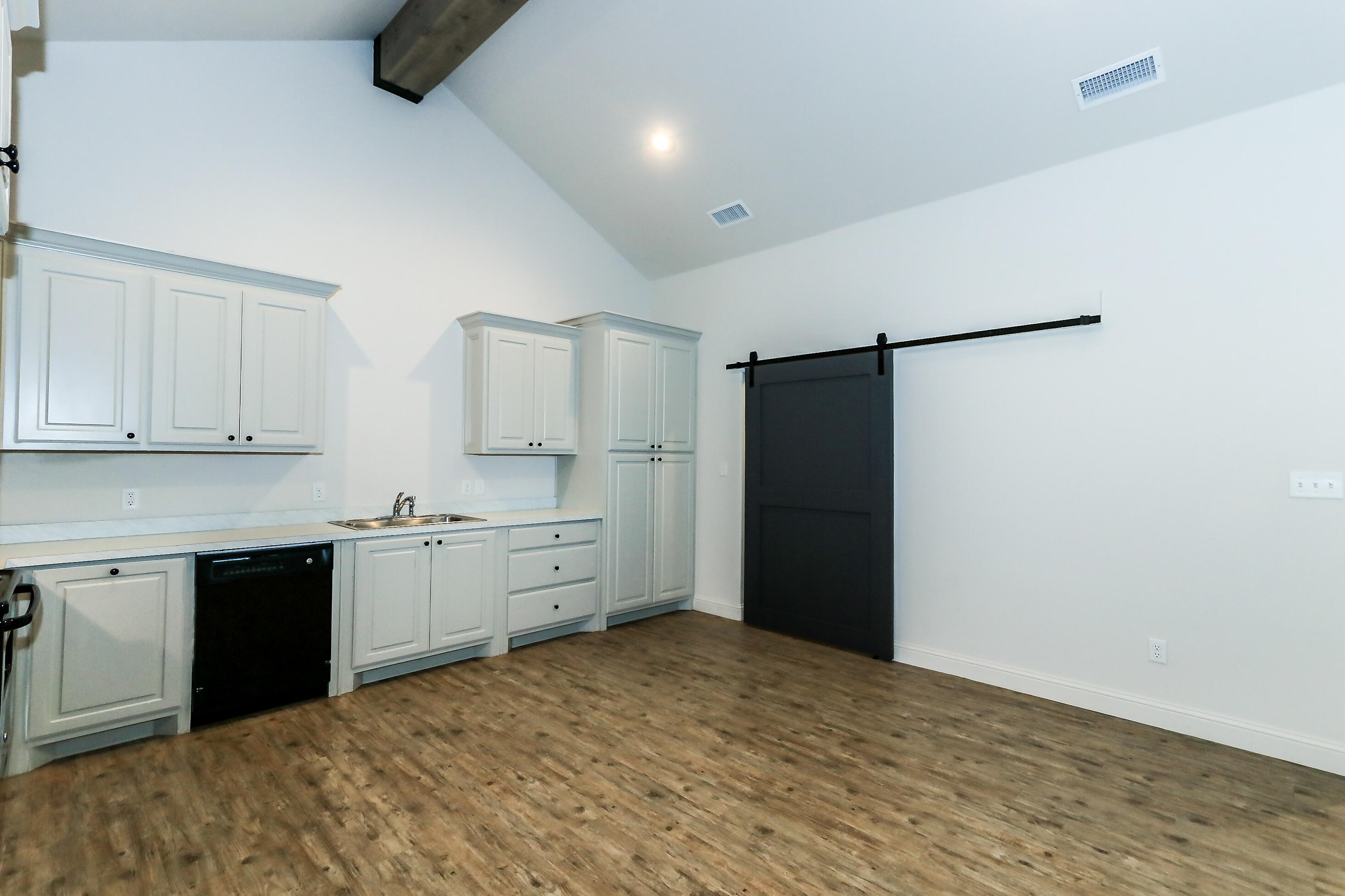 2518 B 111th Street Lubbock, TX 79423 - Photo 10 of 23 a kitchen with granite countertop a refrigerator and a sink