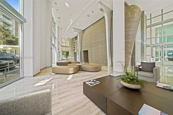 a kitchen with a table chairs stainless steel appliances and cabinets