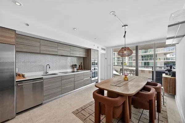 a kitchen with a sink and chairs